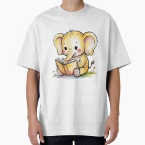 Cute baby elephant in soft butter yellow, sitting and reading an open book — graphic tee